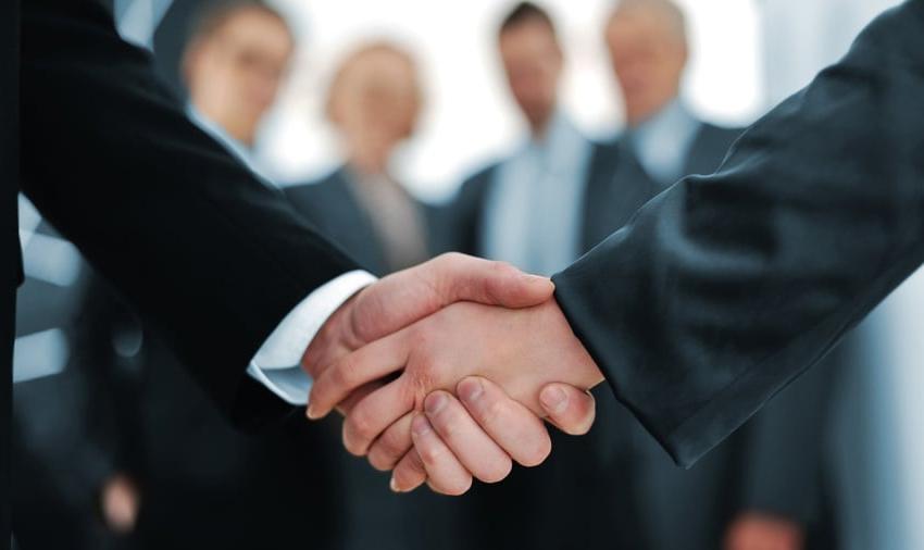 Handshake in front of business people